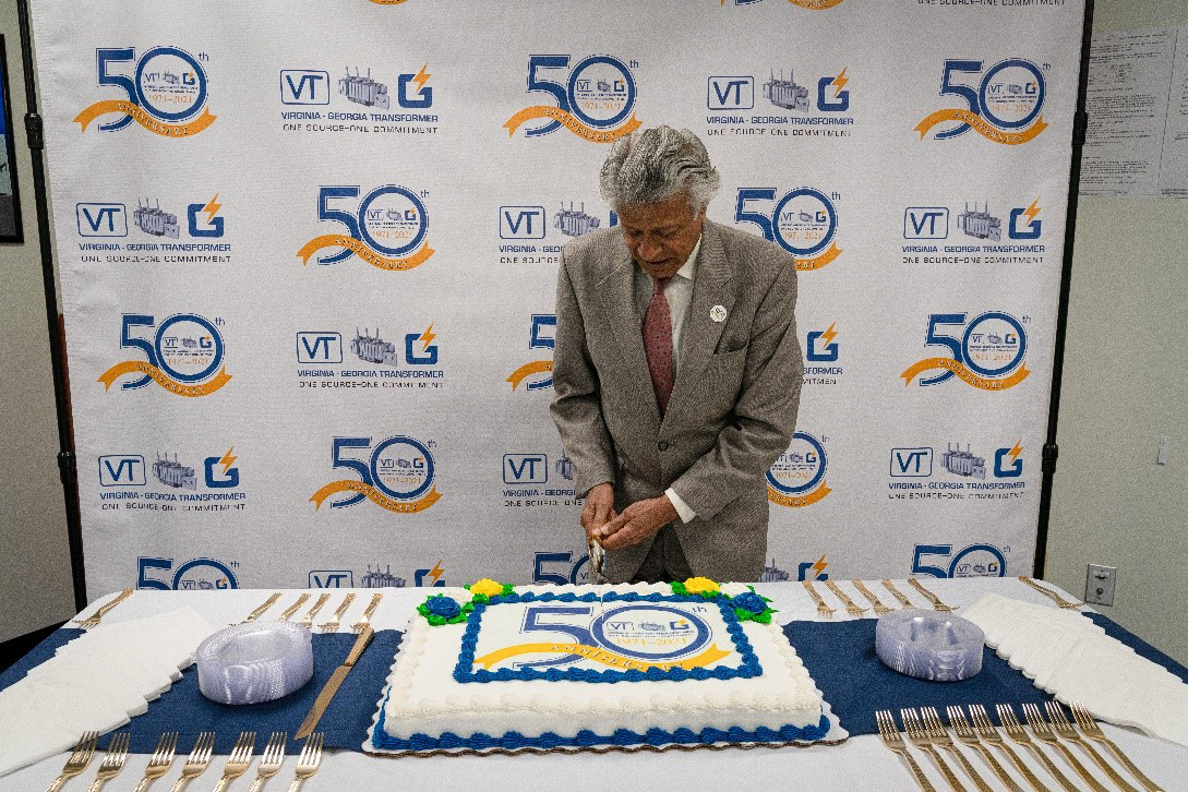 Prabhat Jain cutting 50th anniversary cake.