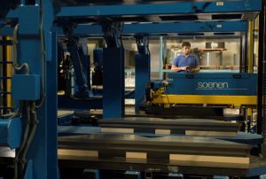 Man operating e-stacker for transformer core.