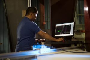 Man viewing e-stacker core test results on a computer screen.