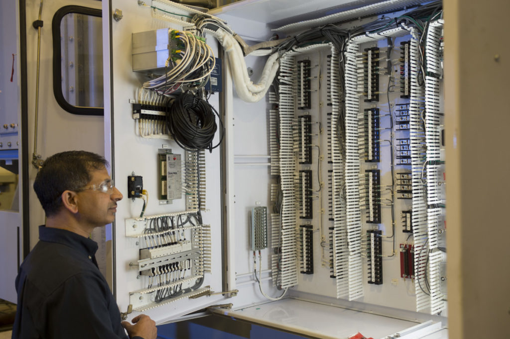 Virginia Transformer engineering working on a custom-designed transformer control box.